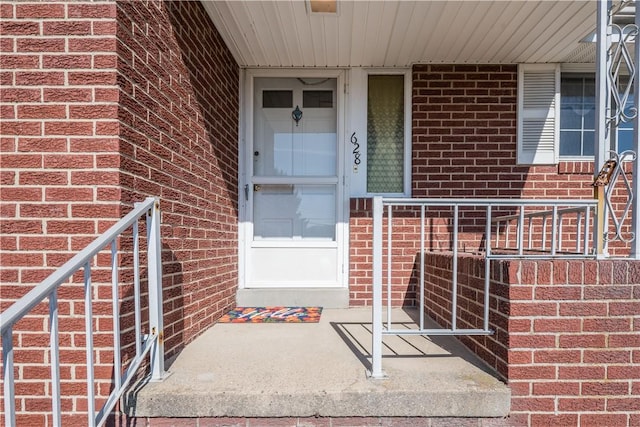 property entrance featuring brick siding