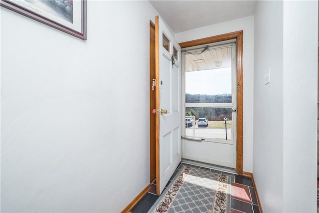 doorway to outside with baseboards