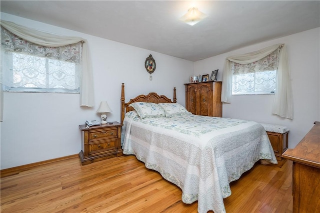 bedroom featuring light wood-style flooring and baseboards