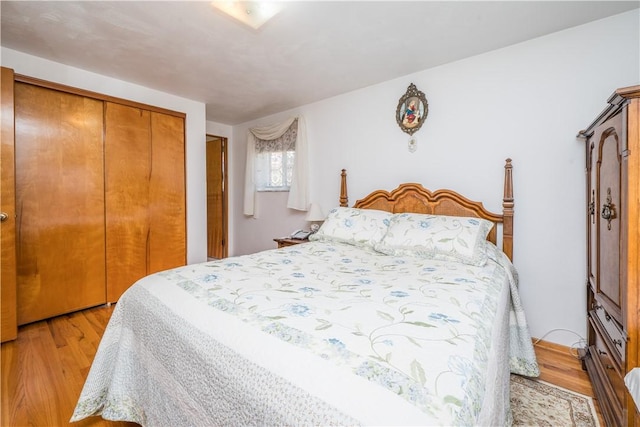 bedroom with light wood-style floors and a closet