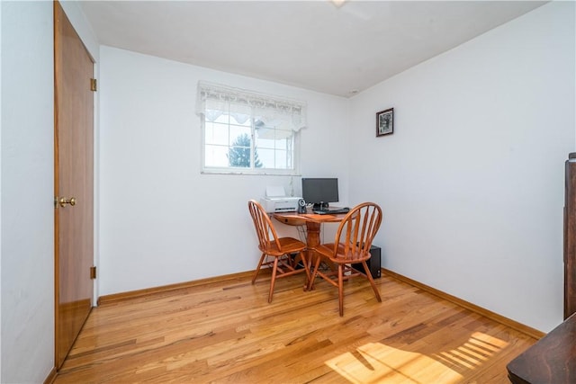 office space featuring light wood-type flooring and baseboards