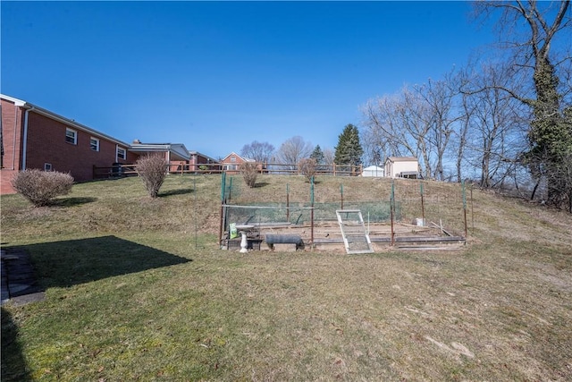 view of yard with a garden and fence