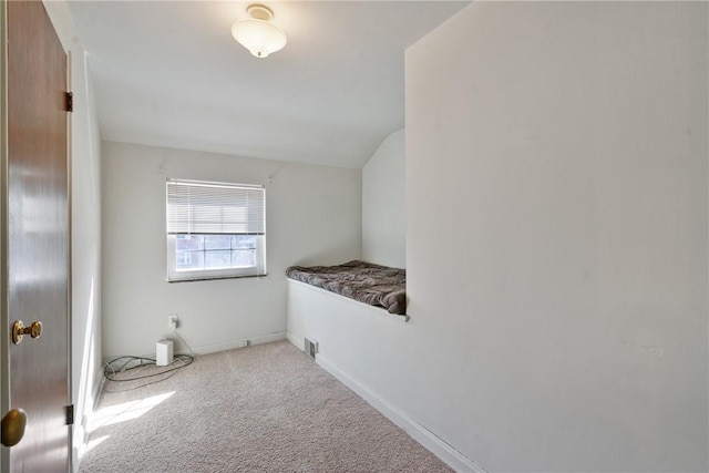 interior space with lofted ceiling, baseboards, and visible vents