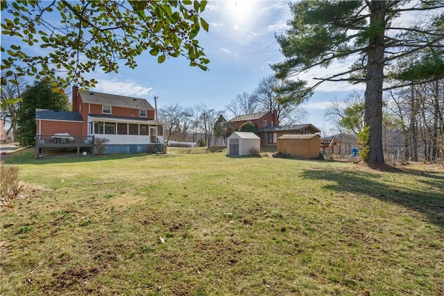 view of yard with a shed, an outdoor structure, and a sunroom