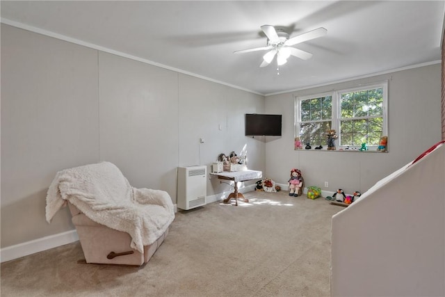 interior space featuring carpet flooring, ceiling fan, crown molding, and baseboards