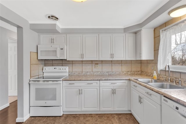 kitchen featuring a sink, visible vents, white appliances, and white cabinets