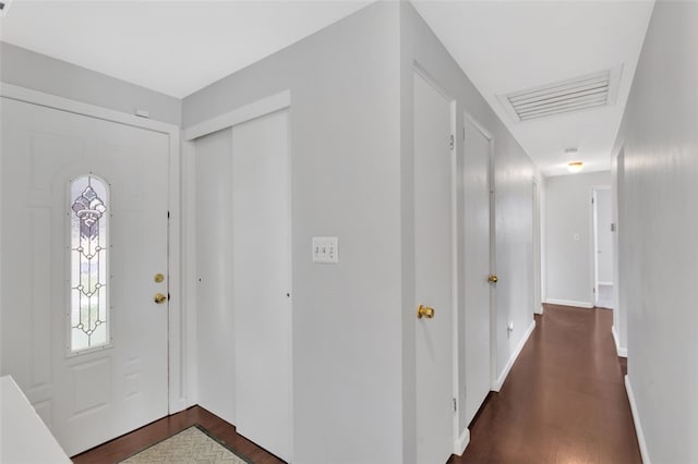 entrance foyer with baseboards, visible vents, and dark wood-style flooring