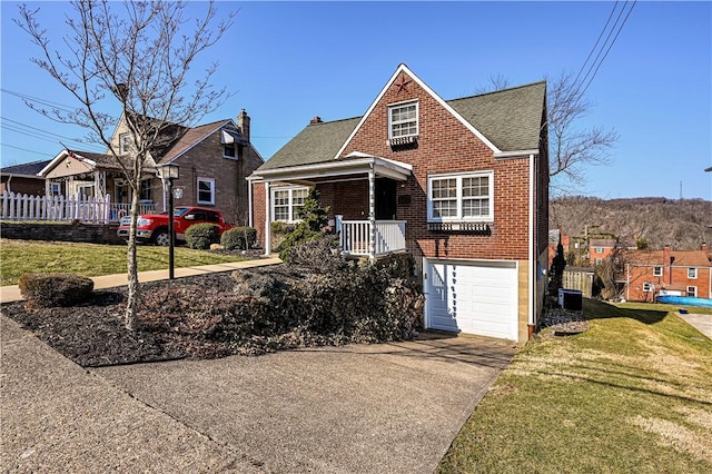 view of front facade with brick siding, a shingled roof, concrete driveway, a front yard, and a garage