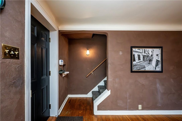 interior space with stairs, wood finished floors, and baseboards