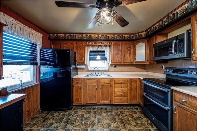 kitchen featuring plenty of natural light, stainless steel appliances, light countertops, and a sink