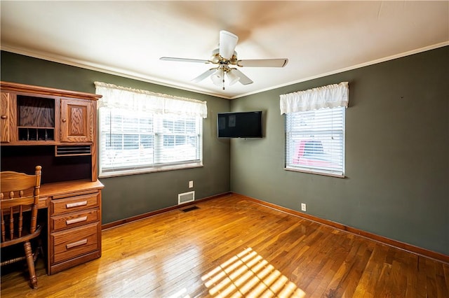 office featuring ceiling fan, crown molding, light wood-type flooring, and baseboards