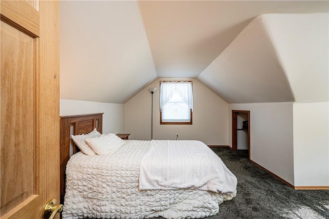 carpeted bedroom featuring baseboards and vaulted ceiling