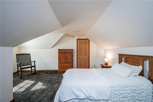 bedroom featuring baseboards, carpet floors, and vaulted ceiling