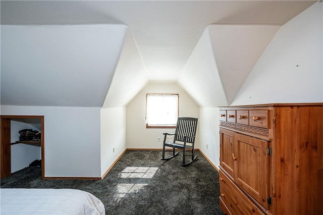 bedroom with vaulted ceiling, baseboards, and dark carpet