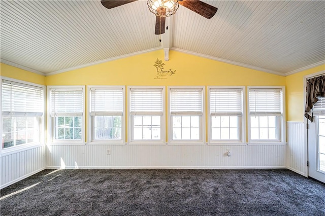 unfurnished sunroom featuring lofted ceiling with beams, plenty of natural light, and a ceiling fan