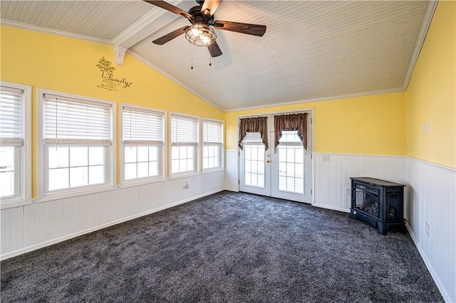 unfurnished sunroom with lofted ceiling with beams, a wood stove, french doors, and ceiling fan