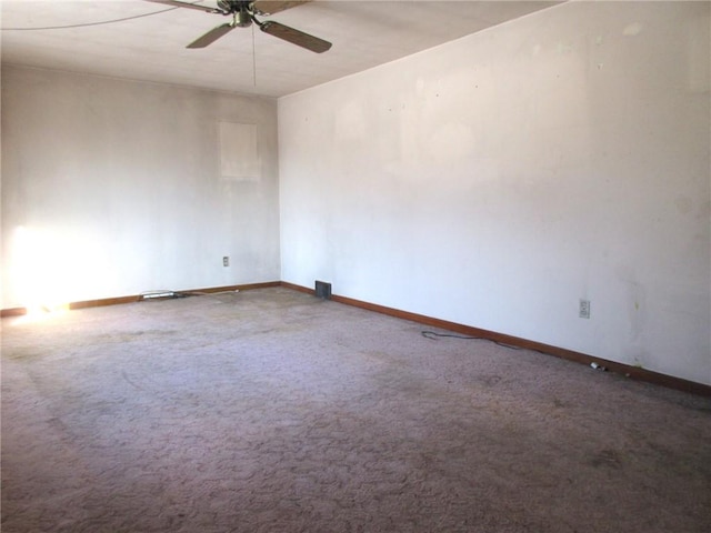 carpeted empty room with baseboards and ceiling fan