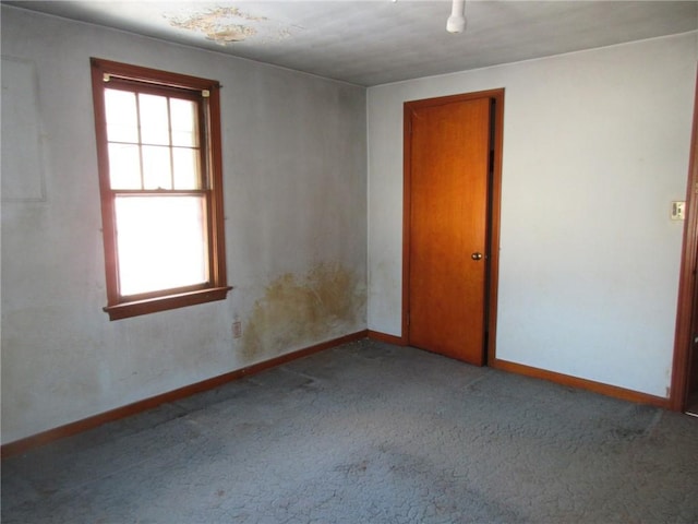 carpeted spare room with baseboards