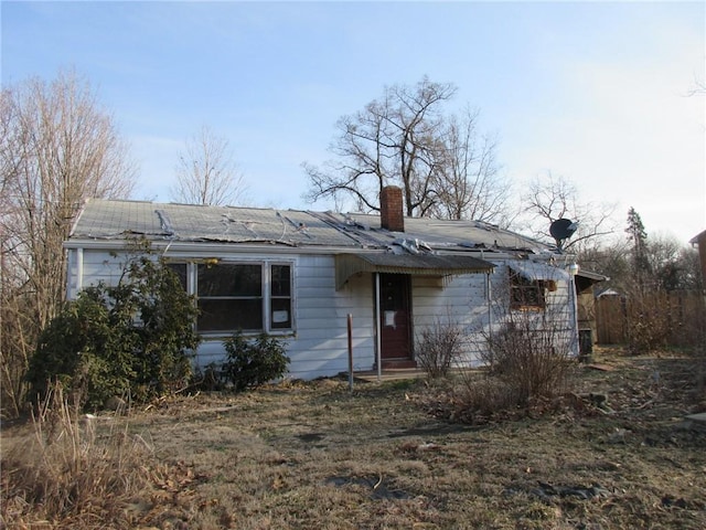 ranch-style house featuring a chimney