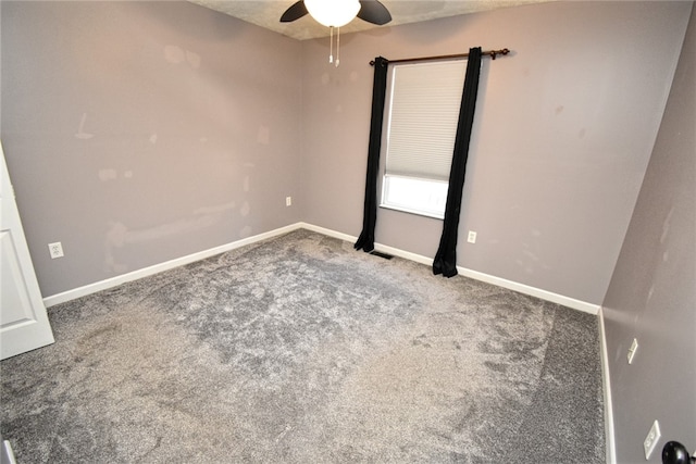 unfurnished room with carpet flooring, visible vents, baseboards, and ceiling fan