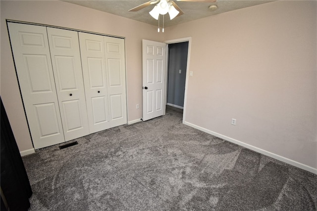 unfurnished bedroom featuring visible vents, baseboards, ceiling fan, a closet, and carpet flooring