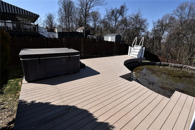 wooden terrace featuring fence, stairs, and a hot tub