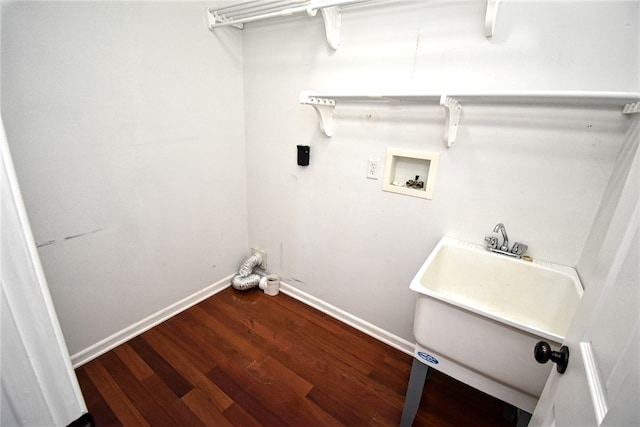 washroom featuring wood finished floors, baseboards, laundry area, a sink, and washer hookup