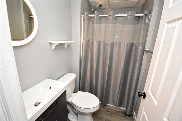 bathroom with toilet, vanity, a shower with curtain, and wood finished floors