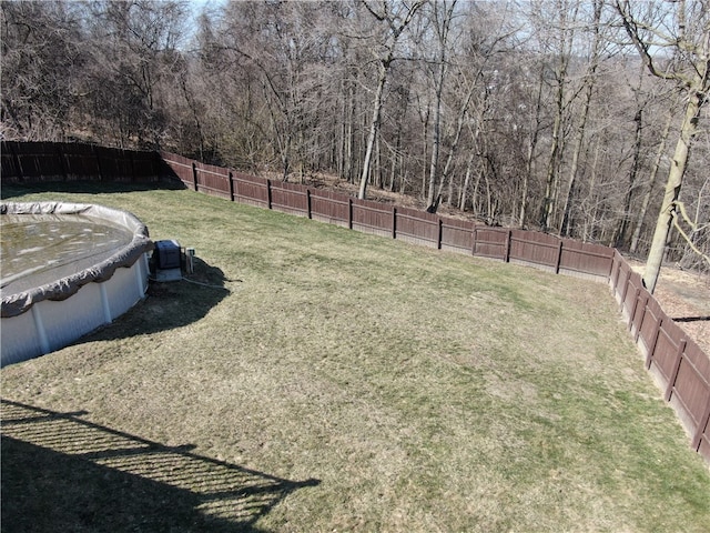 view of yard featuring a fenced in pool and a fenced backyard