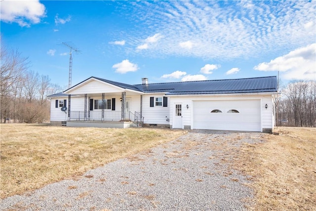 ranch-style house with driveway, covered porch, metal roof, an attached garage, and crawl space