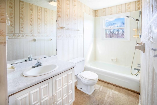 bathroom featuring shower / bathing tub combination, toilet, vanity, and wallpapered walls