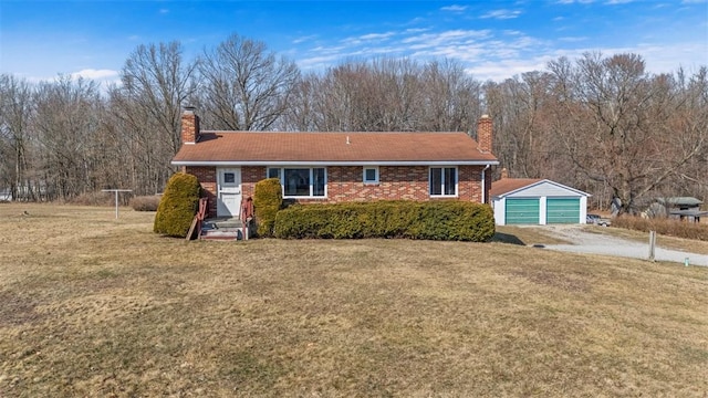 view of front of property featuring a front lawn, an outbuilding, and a chimney