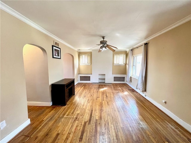 unfurnished living room featuring a ceiling fan, baseboards, light wood-style floors, and crown molding