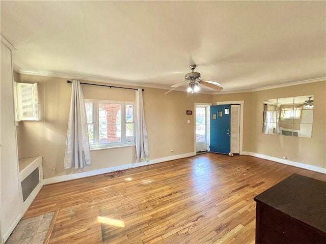 unfurnished living room with baseboards, wood finished floors, a ceiling fan, and ornamental molding