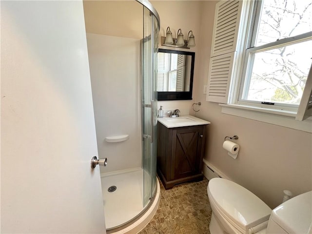 full bathroom with vanity, a shower stall, and toilet