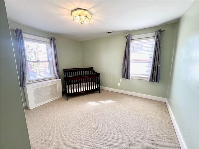 carpeted bedroom featuring baseboards