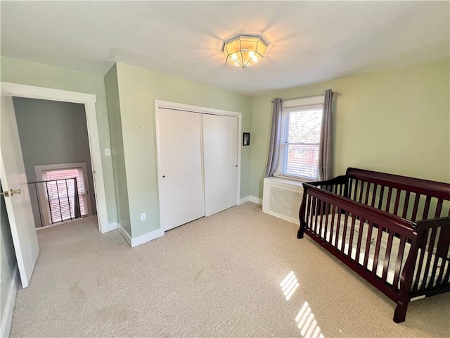 bedroom with a closet, baseboards, and carpet floors