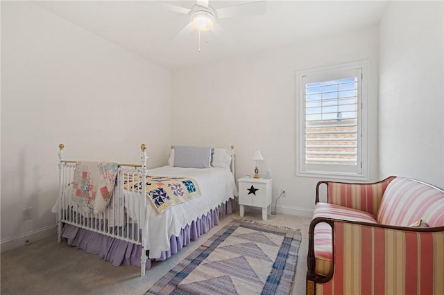 carpeted bedroom featuring baseboards and a ceiling fan