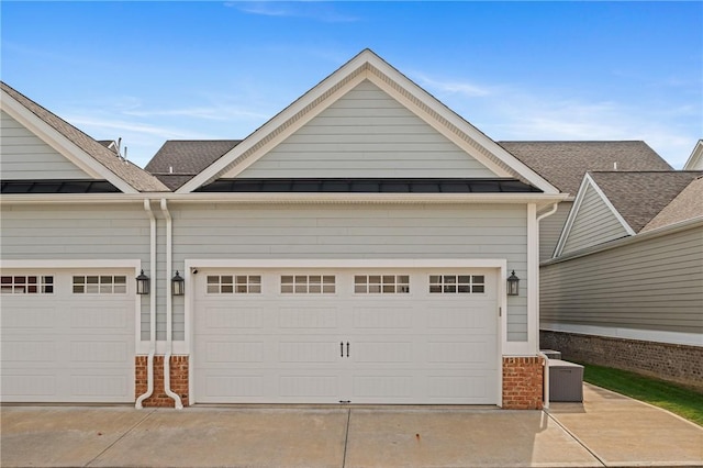 garage featuring concrete driveway