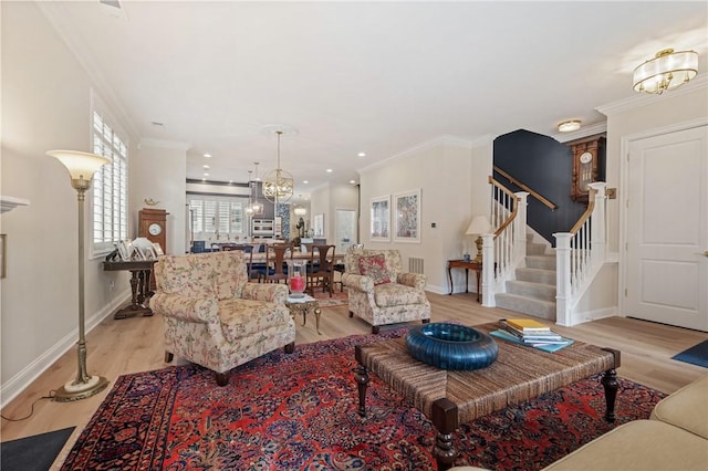 living area with stairs, crown molding, baseboards, and light wood-type flooring