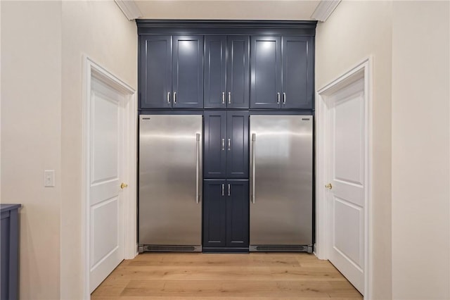 kitchen with stainless steel built in fridge, high end fridge, and light wood-style flooring