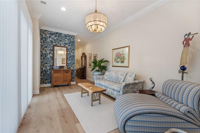 living room with visible vents, crown molding, baseboards, light wood-style flooring, and an inviting chandelier