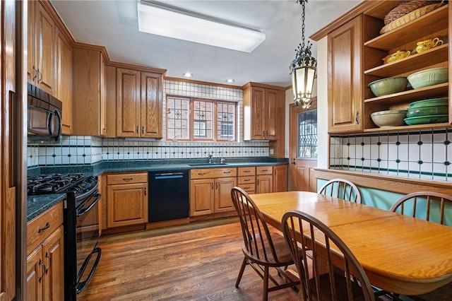 kitchen featuring open shelves, a sink, black appliances, dark countertops, and brown cabinets