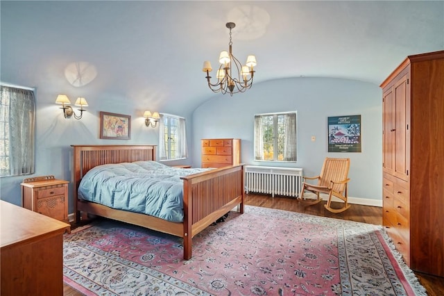 bedroom featuring multiple windows, lofted ceiling, wood finished floors, and radiator heating unit