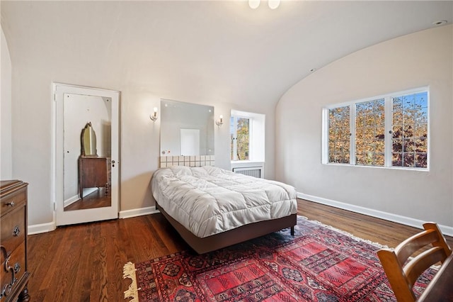 bedroom featuring dark wood-type flooring, baseboards, and vaulted ceiling