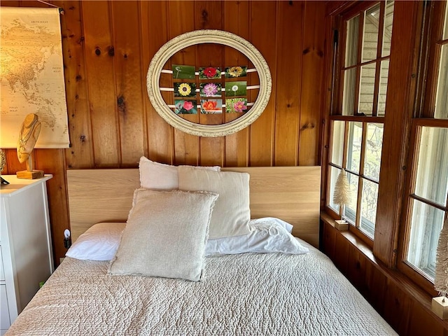 bedroom featuring wood walls