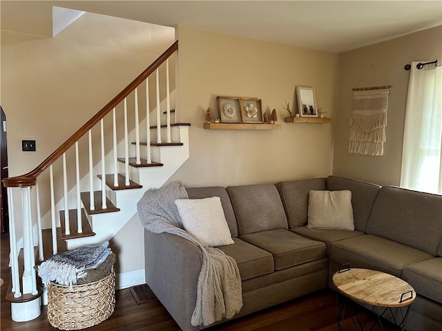 living area featuring stairway, baseboards, visible vents, and wood finished floors