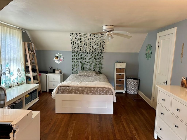 bedroom featuring baseboards, lofted ceiling, ceiling fan, and dark wood-style flooring