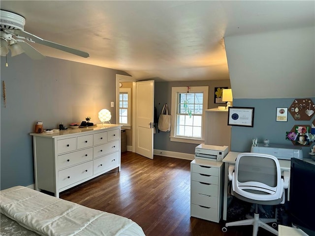 bedroom with baseboards, dark wood-type flooring, and vaulted ceiling