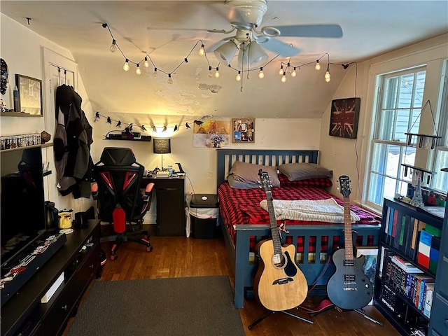 bedroom with lofted ceiling and wood finished floors